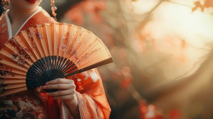 Elegant Asian Fan Held in Autumnal Scenic with Warm Sunlight