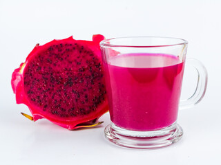 Glass of tasty pitahaya smoothie and fresh dragon fruits - on white background