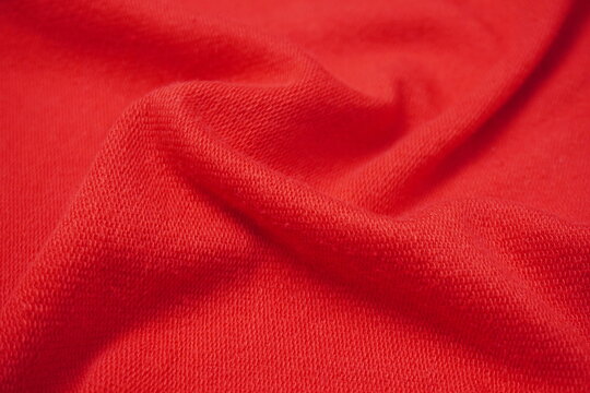 red fabric of sweater with ripples and waves texture background