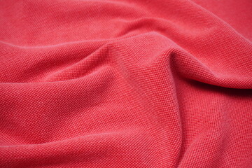texture background of red cotton fabric with ripples and waves