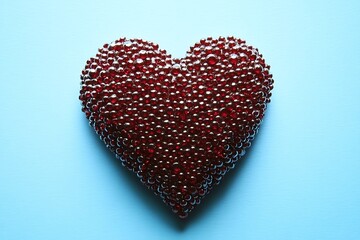 Fototapeta premium Red beaded heart on a blue background