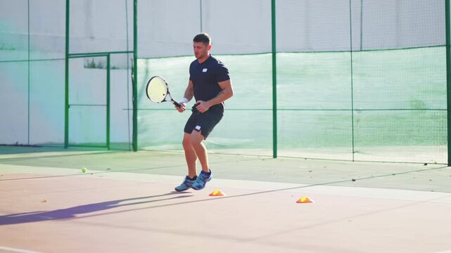 Guy training footwork on tennis court.