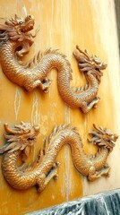 Fototapeta premium Ornate Dragon Reliefs for Chinese New Year Celebrations Featuring Golden Details and Symbolism on a Vibrant Orange Background