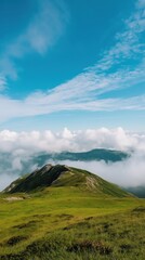Fototapeta premium A mountain with a cloudy sky in the background. The sky is blue and the clouds are white
