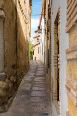 Empty alley between houses in Cordoba, Spain.