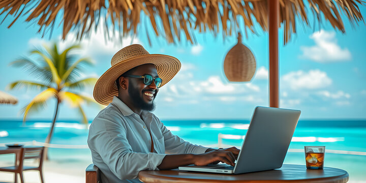 Black young man with laptop working on tropical beach. Relax, smile and happy african american businessman in hat remote vacation business on chair in shadows, blurred summer beach resort background