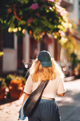 blonde girl in blue pants walking on the street in istanbul. tourist on princes islands in turkey