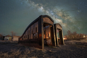 Old London subway entrances abandoned in a desert ghost town in Nevada under the Milky Way Galaxy 