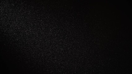 White snow are gently falling against a black background, creating a subtle and elegant visual effect, perfect as an overlay graphic element for various video projects