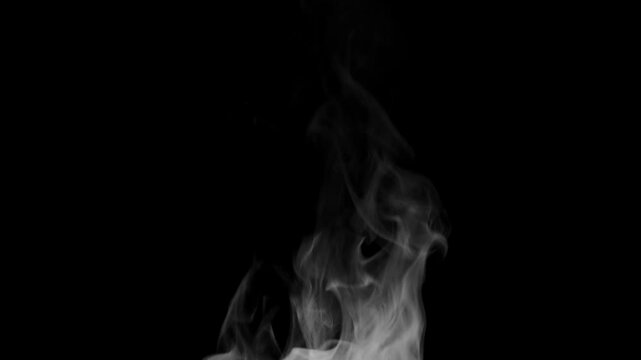 Trickle of Steam Slowly Rising from the Cup. White steam rises light, graceful twists on a black background. Slow motion. Footage is perfect for the layer with different blending modes.