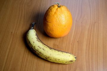 Colorful fruits resting on a wooden table in bright daylight