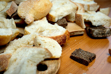 Bread pieces scattered on a wooden table after a festive gathering