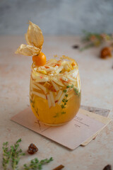 Apple cider bourbon fall cocktail with cinnamon, thyme, honey and physalis for single serving....