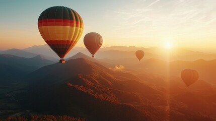 Obraz premium Breathtaking Sunrise Aerial Adventure with Hot Air Balloons Floating Over Majestic Mountain Landscape
