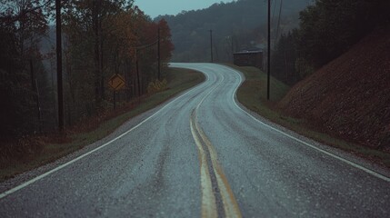 Fototapeta premium Winding road, autumn rain, hills, misty background; travel imagery