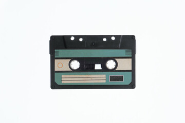 A vintage audio cassette tape with an blue and black label, isolated on a white background, evokes nostalgia and retro vibes.