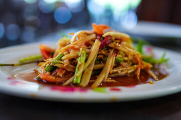 Spicy papaya salad or Som Tum in Thai language, is a spicy Thai foods