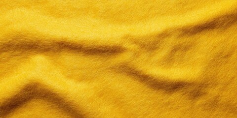 Textured yellow felt fabric background showcasing rich golden hues with soft folds and shadows for...