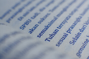  Photo of a book page that focuses on the writing of Tuhan, mean the god in the Indonesian language