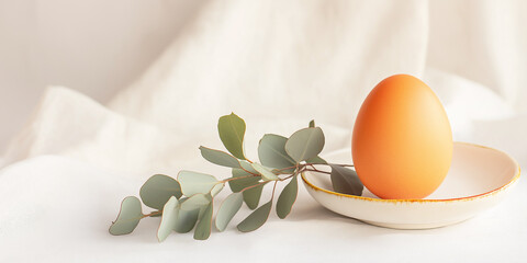 Minimal easter egg with eucalyptus branch decor, minimal background