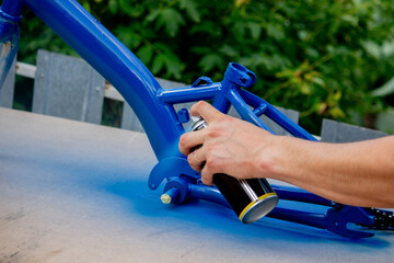 Spray Painting a Bicycle Frame Outdoors