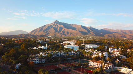 aerial view of a Tennis Club and the Marbella Grand Mosque in front of the famous Pico de la Concha...