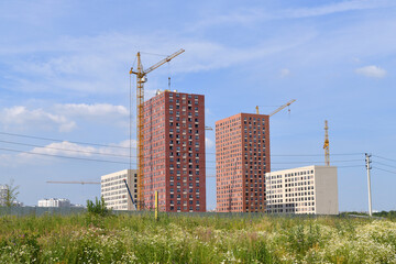 Modern multi-storey residential building in Moscow surrounded by trees , Russia