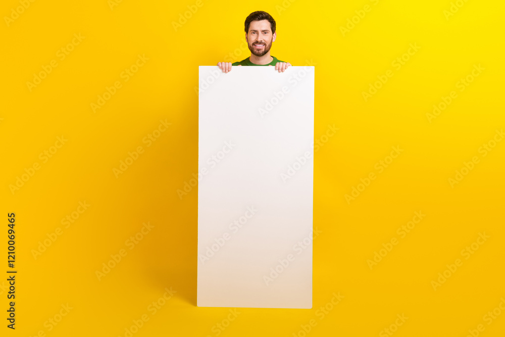 Aufkleber Full body length photo cadre of cheerful handsome man holding huge phone display menu web message isolated on yellow color background