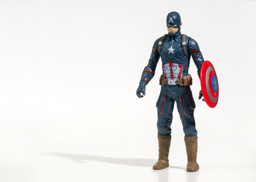 Captain America figurine standing with shield on white background