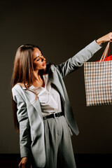 Woman enjoying a shopping spree with stylish bags in a contemporary setting