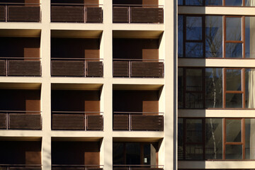 Beige building with brown balconies.