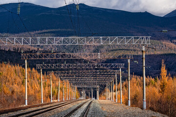 Railway tracks against a beautiful sunset and mountains. Transportation industry	
