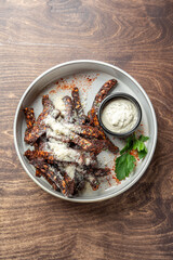 A plate of crispy garlic croutons, garnished with herbs and served with a flavorful dipping sauce. Perfect for highlighting appetizing snacks or side dishes in food photography.