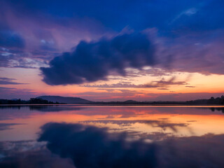 Fototapeta premium Morning light, mountain range, clouds, reflections on water
