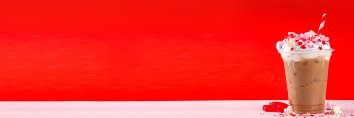 Valentine day iced coffee latte drink  with whipped cream, heart shaped marshmallow and sugar sprinkles