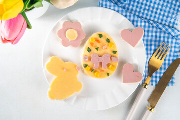 Easter kids breakfast sandwiches with cheese and sausage, fresh vegetables, creative toast sandwiches made with cookie cutter top view copy space