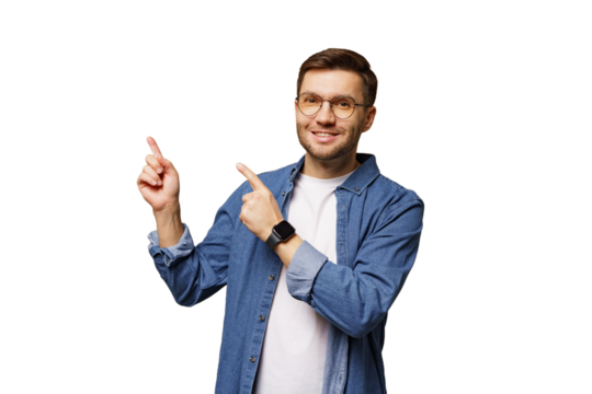 Smiling man in blue shirt pointing with both hands toward invisible objects in bright background