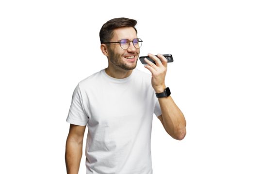 Young man using voice recognition technology to send a message while smiling in a bright setting