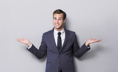 Happy smile businessman business man wear corporate suit jacket, show point hands smth or free space for slogan, advertise text, isolate grey gray background. Make right choice advice - concept image.