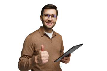 Man in glasses smiling and giving a thumbs up while holding a tablet indoors during daytime