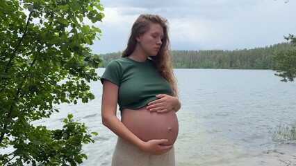 Sad frustrated young pregnant woman on natural background. Problems with pregnancy.