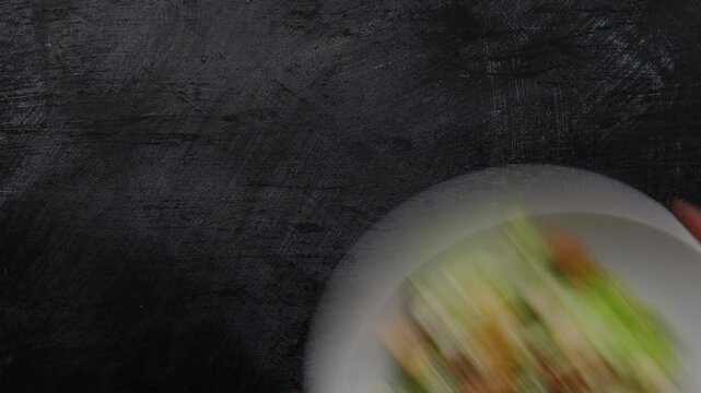 Serving a Delicious Bowl of Caesar Salad on a Concrete Table Shot from Above