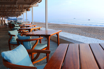 Empty tables in cafes by ocean or on seashore. Outdoor cafe. Concept of recreation.