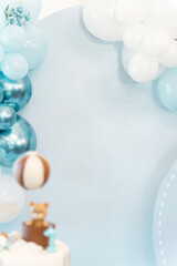 Decoration for first birthday of boy or a girl. Lot ballons, cake with cute bear. Free space for text. Celebration concept.