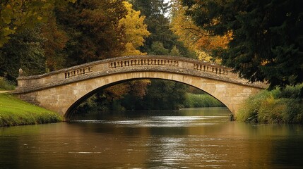 Fototapeta premium A historic stone bridge spanning a peaceful river, a fine example of classic architecture.