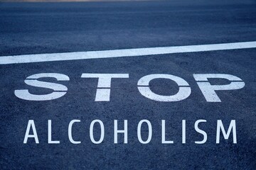 stop alcoholism concept. widespread problem of alcohol addiction. words written on a stop sign.