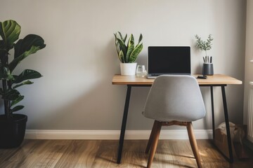 Fototapeta premium Modern home office setup featuring laptop, plants, and minimalist design