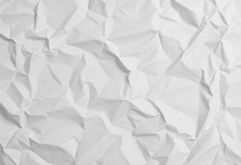 Obraz premium A crumpled white paper texture with visible folds and creases, creating a distressed appearance