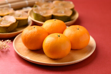 Mandarin orange fruit and sticky rice cake (Nian Gao), Chinese New Year cake on red background