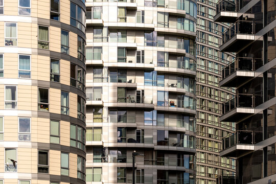 This image captures the intricate designs of various high-rise building facades, showcasing a blend of textures and reflections that define modern urban living in London UK